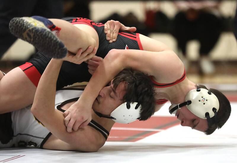 Huntley’s Logan Drews tries to win  Jacobs’ Anthony Martinez during the 120—pound match of a Fox Valley Conference wrestling meet on Thursday, Dec. 11, 2025, at Huntley High School.
