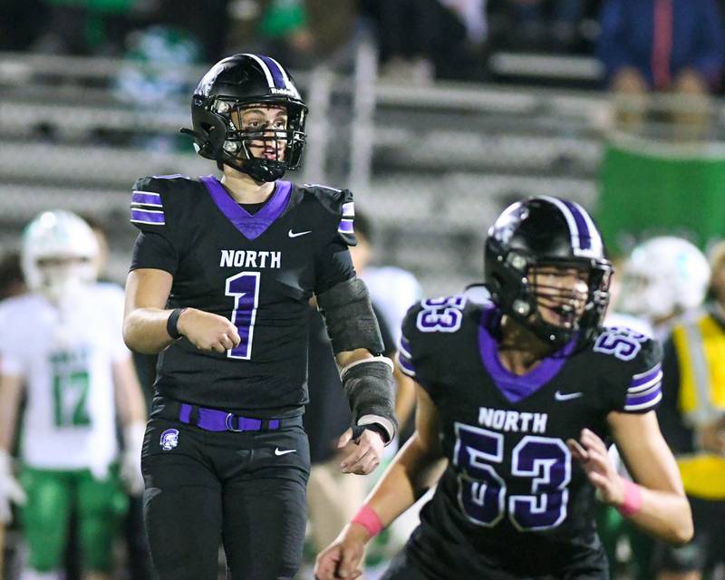 Downers Grove North's Owen Lansu (1) watches his pass get caught for a touchdown during the game against York High School on Friday Oct. 10, 2025, held at Downers Grove North High School.