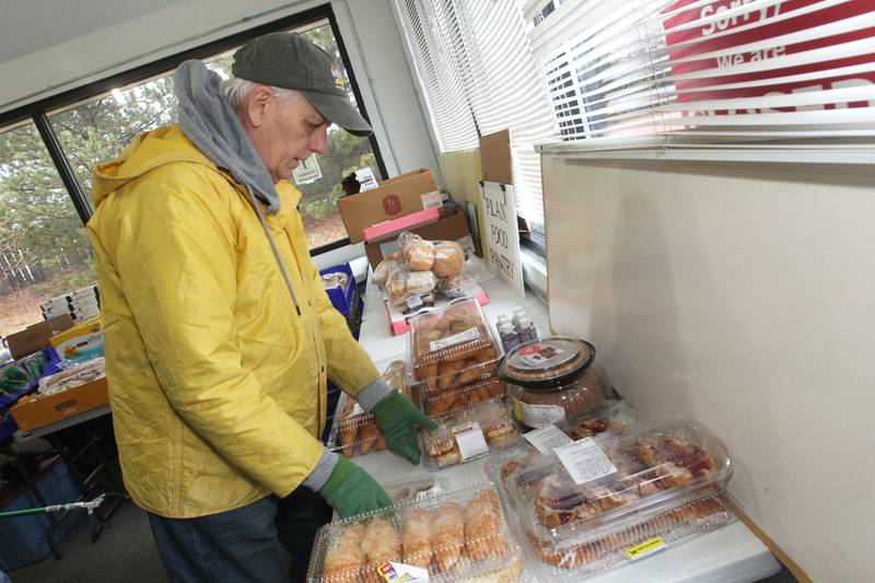 Vic Ligenza, volunteer, sorts baked goods to be given to patrons at the P.L.A.N. Food Pantry in Round Lake Beach.