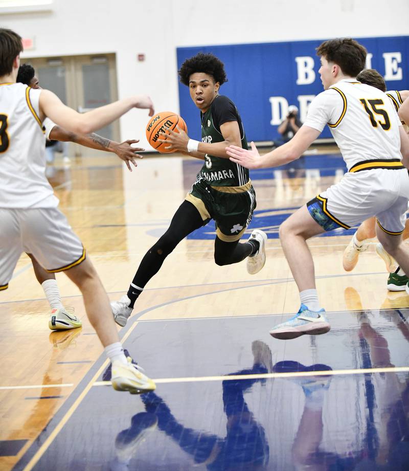 Bishop McNamara's Willie Felton maneuvers through Joliet Catholic Academy defenders in the lane during the Fightin' Irish's 79-67 victory over the Hilltoppers in the IHSA Class 2A Peotone Sectional semifinal on March 4, 2025.