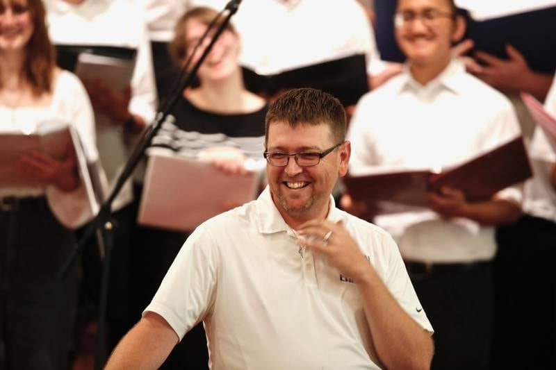 PHS choral director Brandon Crawford enjoys a light moment during Wednesday's debut of the PHS summer choir. The concert was moved from Soldiers and Sailors Park to Covenant Church due to the rain.
