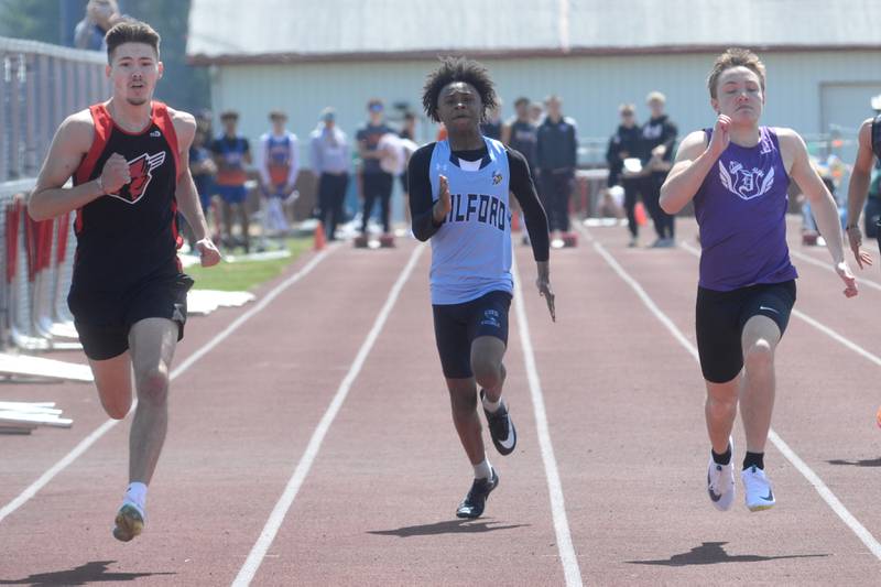 Forreston-Polo's Noah Dewey (left), Dixon's Adam Staples (right) and a Guilford runner race to the finish line in the 100 meters  at the Gebhardt-Worley Invitational at Oregon High School on Saturday, April 12, 2025.