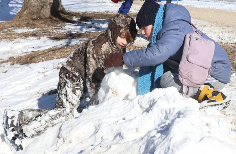 Caiden Fogal and Wren Kirkpatrick of Mackinaw, play in the snow during the Lowaneu Cub Scout Yukon on Saturday, Jan. 31, 2026 at Hall Township Echo Bluff Park in Spring Valley.