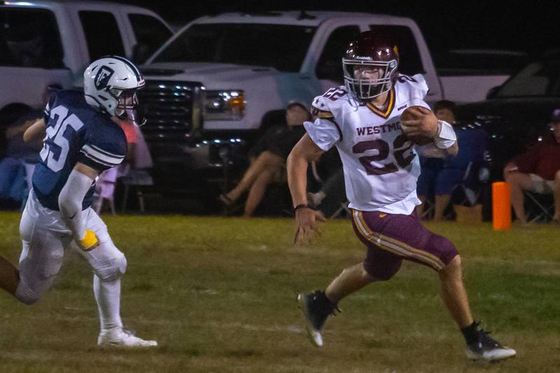Lucas Fears of Westmont runs ball whilst being trailed by Braydin Eplin of Fieldcrest on Friday, September 20, 2024 at Fieldcrest high school in Minonk.