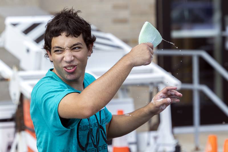 Leo Francis of Newman sends out suds from a sponge Friday, Aug. 2, 2024, during the Building Lasting Impressions that Never Die (BLIND) car wash in Sterling. The student leadership group has 108 high school students from Morrison, Fulton, Polo, Prophetstown, Newman and Rock Falls.