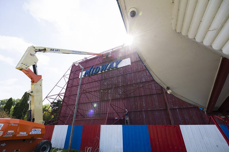 The early day sun beats down on Dylan Ingram and Kevin Street Tuesday, August 22, 2023 as they work to renovated the front and back sides of the Midway Drive-In screen in Sterling. Tucker Painting of Dixon is working the spruce up the screen for the Labor Day showings on Sept. 2 and 3.