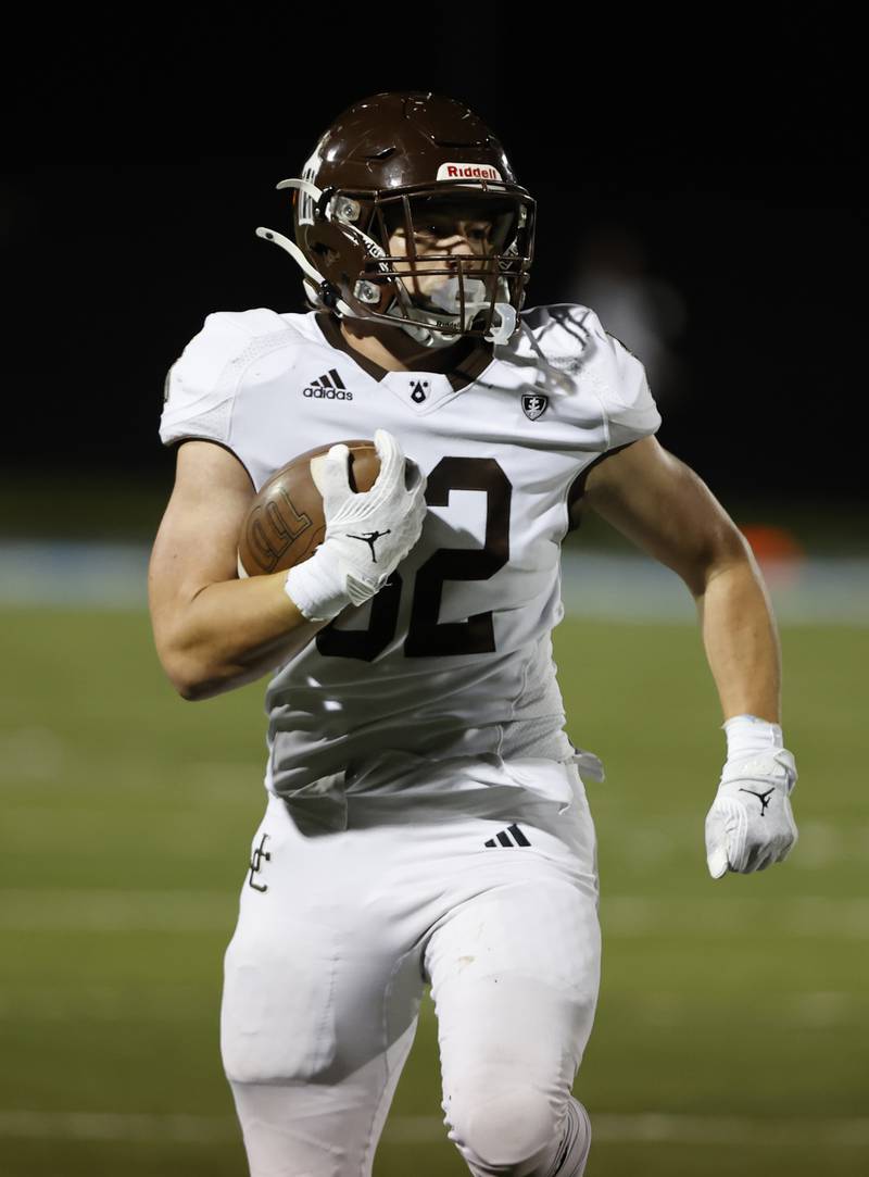 Joliet Catholic's Vincent Bremmer II (32) runs with the ball during the varsity football game between Joliet Catholic and Nazareth academies on Friday, Sep. 27, 2024 in La Grange Park.