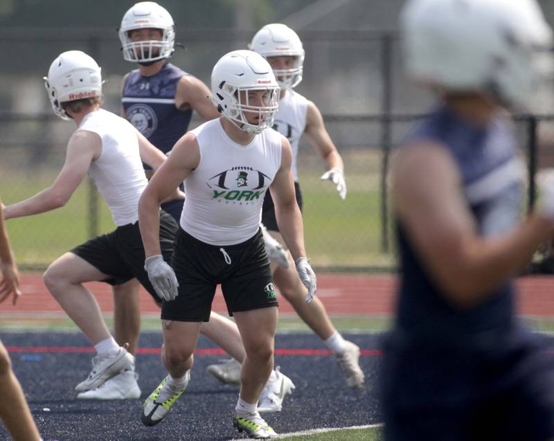 York’s Cole Ostendorf (center) playes defense during a 7-on-7 football tournament at West Aurora High School on Friday, June 23, 2023.