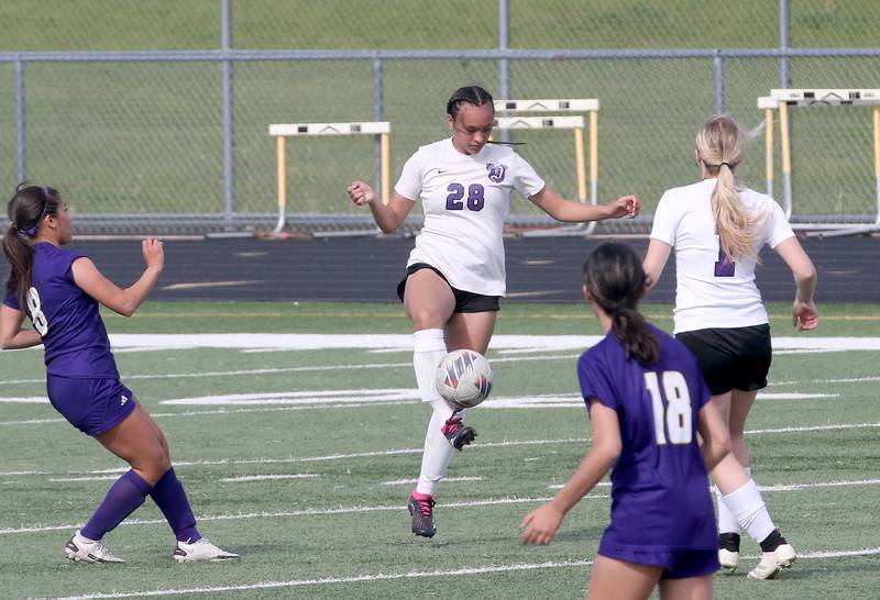 Dixon's Kamille Prather kicks the ball away from Mendota defenders Linnea Escatel and Sienna Gonzalez on Wednesday, May 1, 2024 at Mendota High School.