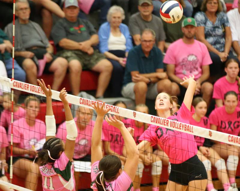 L-P's Addison Urbanski spikes the ball past St. Bede's Amanda Wojcik and teammate Bella Piter during the "Cavs 4 A Cause" pink night game on Tuesday, Sept. 26, 2023 at Sellett Gymnasium.