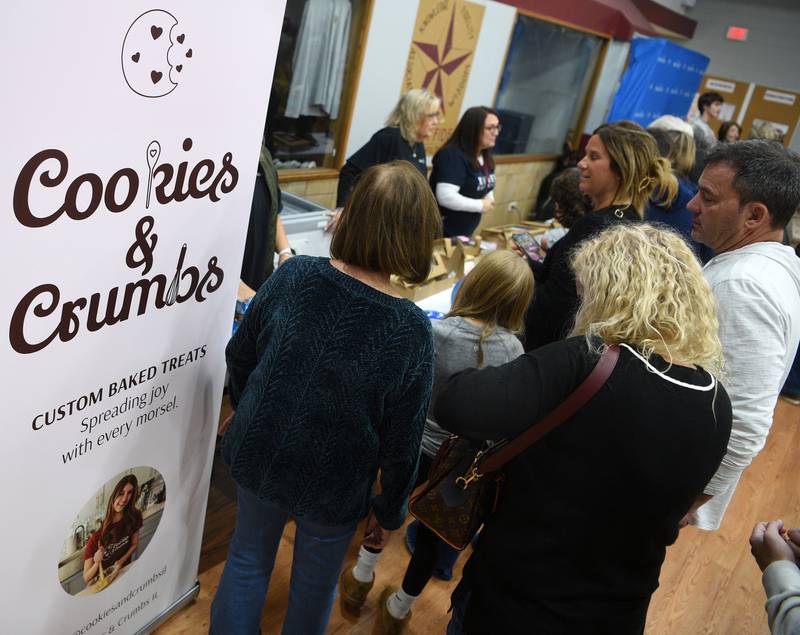 Folks line up to thy Neysa Bianco’s baking from her new company Cookies & Crumbs, which she started with the help of the Make-A-Wish foundation.