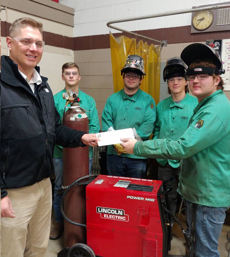 DeKalb County Community Foundation Board Member Justin Wegener, left, with IVVC Welding & Fabrication students.