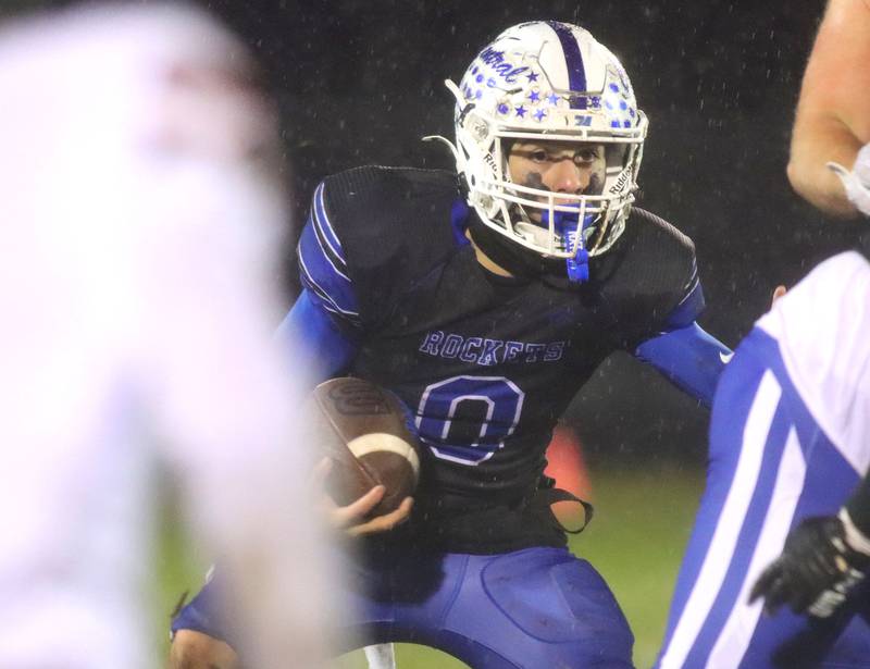 Burlington Central’s Henry Deering moves the ball against Harlem in IHSA football Class 6A second-round playoff action at Central High School in Burlington on Saturday, November 8, 2025.