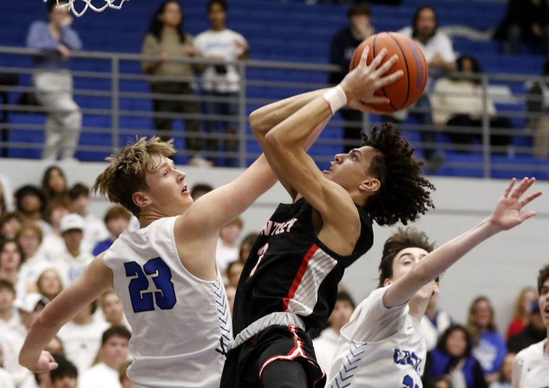 Huntley's Bryce Walker shoots the ball over Burlington Central's Jacob Johnson during a Fox Valley Conference boys basketball game on Friday, Dec. 15, 2023, at Burlington Central High School.