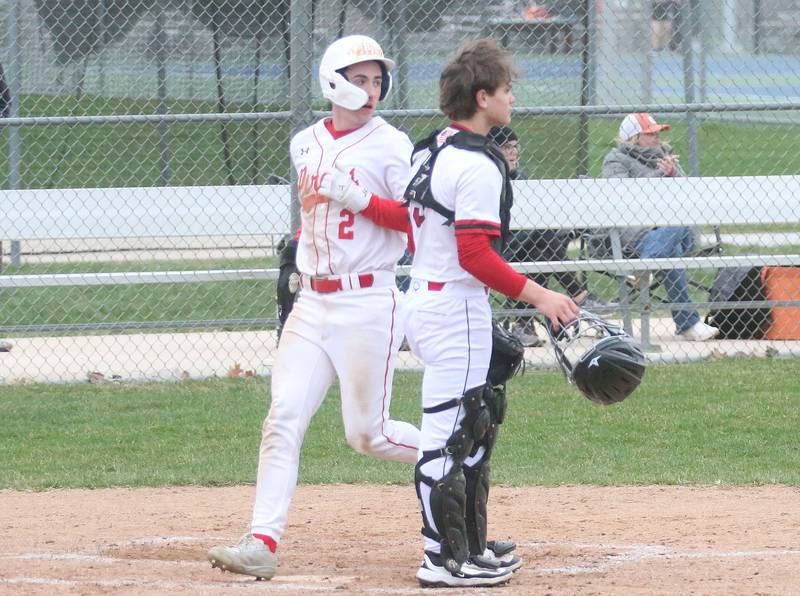 Ottawa's Jacob Rosetto steps on home plate to score a run as Hall catcher Greyson Bickett watches the play on Tuesday, April 1, 2025 at Ottawa High School.