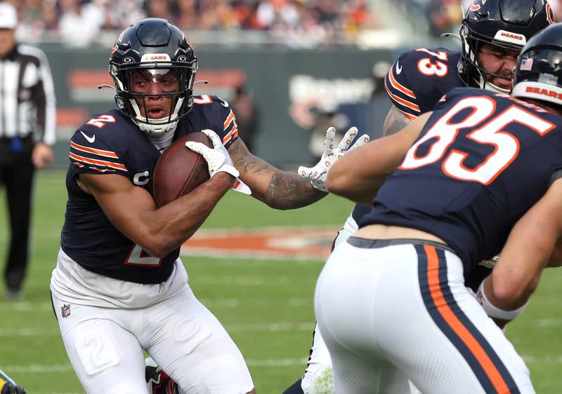 Chicago Bears wide receiver DJ Moore follows the blocking of Chicago Bears tight end Cole Kmet through the Green Bay Packer defense Sunday, Nov. 17, 2024, during their game at Soldier Field in Chicago.