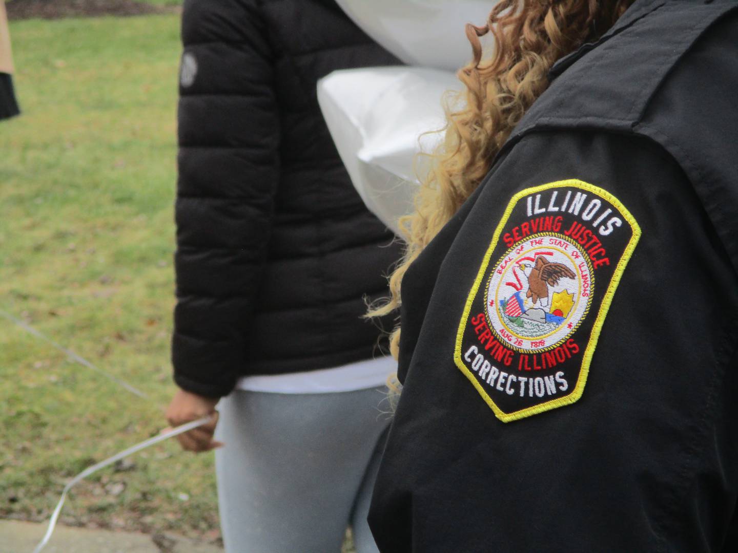 An employee of the Illinois Department of Corrections, where Christine Esters worked before she became one of the seven victims in a shooting rampage on West Acres Road in Joliet, joined a vigil held Sunday, Jan. 28, 2024 to pay tributde to the victims.