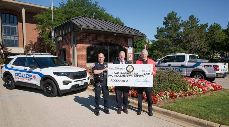 Will County State's Attorney James Glasgow (right) presented a $2,500 check to Lewis University President David Livingston (center) for a new flock camera.