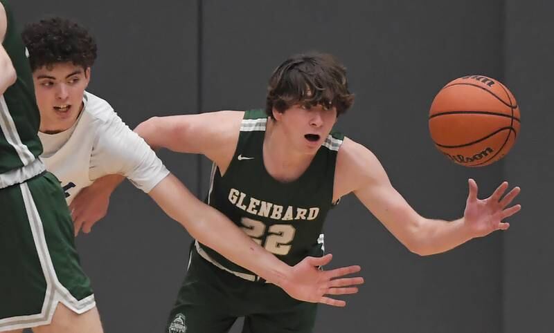 Burlington Central’s Myles Lowe and Glenbard West’s Bennett Schwanke battle for the ball in a boys basketball game in Burlington on Wednesday, Jan. 3, 2023.