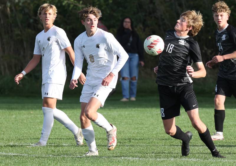 Kaneland's Matthew Mitchinson tries to push the ball ahead of two Sycamore players during their game Monday, Oct. 7, 2024, at Kaneland High School in Maple Park.