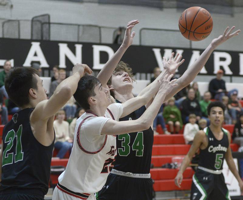 Woodland’s Nick Plesko battles for a rebound with Cornerstone Christian’s Josh Kalmes and Will Thoma Monday in the 1st period at Woodland