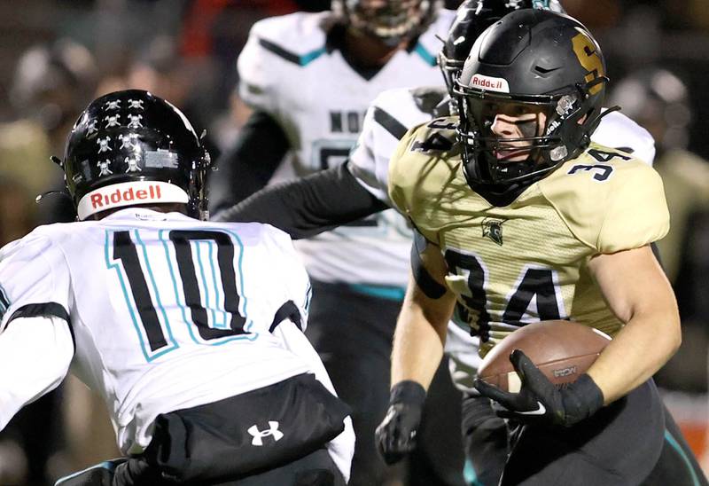 Sycamore's Joey Puleo looks to get by Woodstock North's Parker Menzel during their game Friday Oct. 7, 2022, at Sycamore High School.
