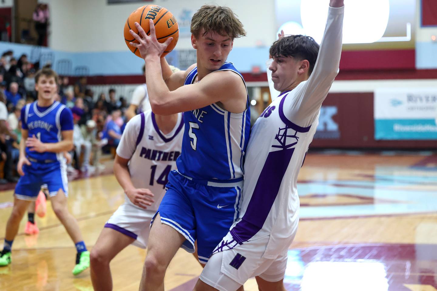 Peotone's Nate Wehrmann secures a rebound under pressure from Manteno's Cade Bechard during the Panthers' 60-49 victory over Peotone in the 75th Kankakee Holiday Tournament opening round on Friday, Dec. 26, 2025.