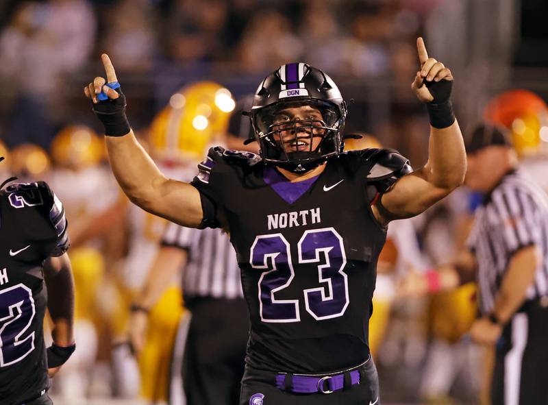 Downers Grove North's Joe LaSota (23) celebrates his recovery of a fumble during the varsity football game between Downers Grove North and Lyons Township on Friday, Oct. 11, 2024 in Downers Grove.