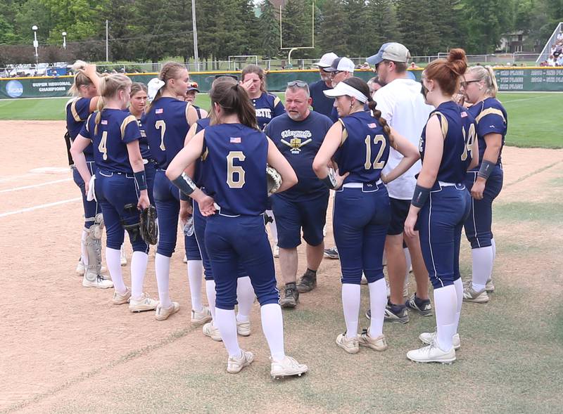 Members of the Marquette softball team gather with their head coach David Tkach between innings while facing LeRoy during the Class 1A Supersectional game on Monday, May 29, 2023 at Illinois Wesleyan University in Bloomington.