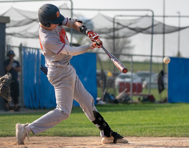 Oswego’s Tyler Stack (25) makes contact against Oswego East during a baseball game at Oswego East High School on Tuesday, May 10, 2022.