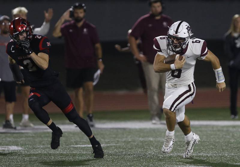 Prairie Ridge's Luke Vanderwiel (right) runs for a touchdown as Huntley's William Laughlin tries to chase him down during a Fox Valley Conference football game on Friday, Oct. 3, 2025, at Huntley High School.