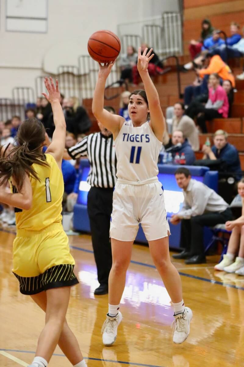 Princeton's Olivia Gartin spots up for a 3 against Putnam County in tournament play at Princeton Monday. She had 18 points to lead the Tigresses to a 62-36 win.