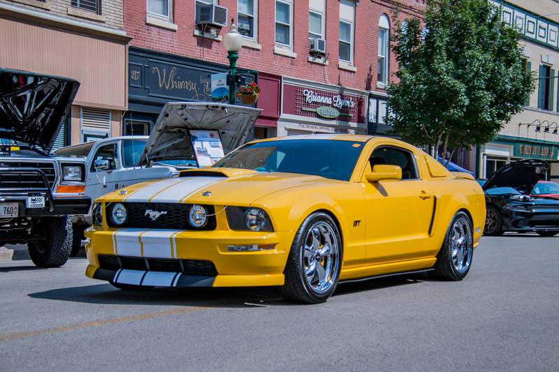 A Ford Mustang rolls through the crowd at Morris Cruise night.