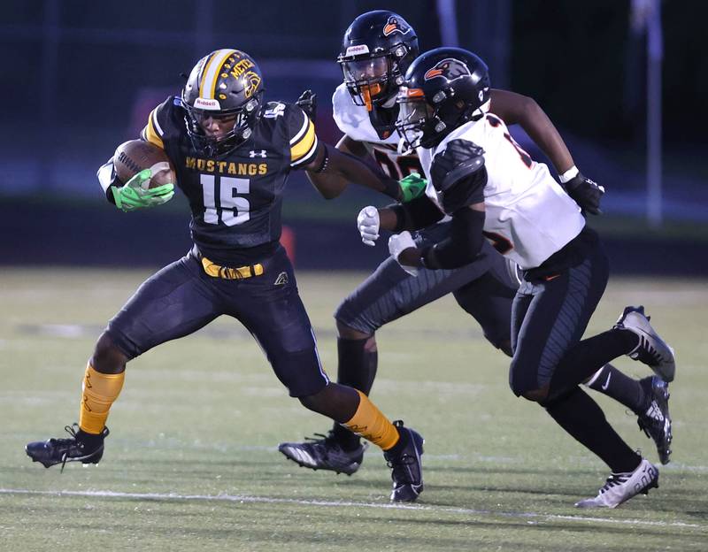 Metea Valley's Charles Flowers gets outside of two DeKalb defenders during their game Friday, Sept 15, 2023, at Metea Valley High School in Aurora.