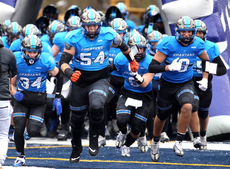 St. Francis players take the field before their Class 4A semifinal game against Providence in Wheaton on Saturday, Nov. 19, 2022.