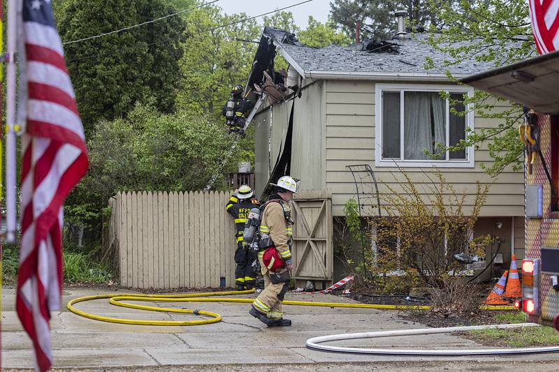 Firefighters work at the scene of a fire in the 800 block of Avenue I in Sterling on Monday, April 27, 2026.