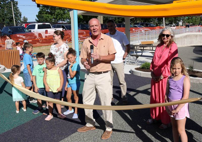 Dag Grada, DeKalb Park Board president, makes some remarks before the ribbon cutting Friday, June 14, 2024, at the new playground at Hopkins Park. The park district was hosting a Dedication Celebration event at the park for the grand opening of the new playground and racquet courts.