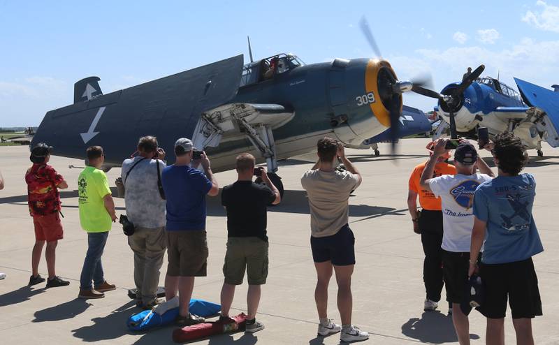 Spectators gather as a TBM departs during the 10th annual TBM Avenger Reunion and Airshow on Friday, May 16, 2025 at the Illinois Valley Regional Airport in Peru.