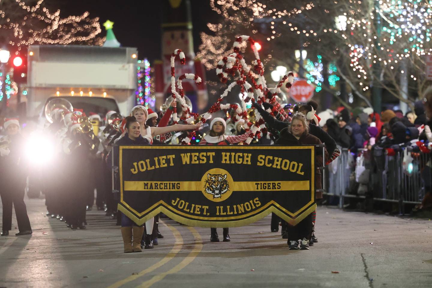 Joliet West High School Marching Tigers performs at the Joliet Light up the Holidays Parade in downtown Joliet on Friday, Nov. 24, 2023.