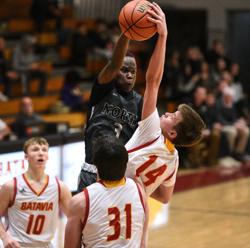 Glenbard North's Josh Abushanab (3) has his shot blocked by Batavia's Jack Ambrose during Tuesday’s boys basketball game in Batavia.