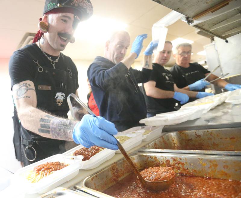 Zak Burns spoons out sauce to cover pasta in the kitchen for the 27th annual Lighted Way Spaghetti Dinner on Monday, April 20. 2025 at Uptown downtown La Salle.
