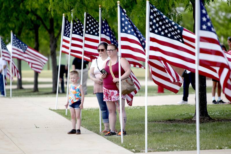 Onlookers watch as a processional begins during a funeral in honor of Kane County Sheriff K9 Hudson, who lost his life in the line of duty last month, on Thursday, June 1, 2023 at Kaneland Harter Middle School in Sugar Grove.