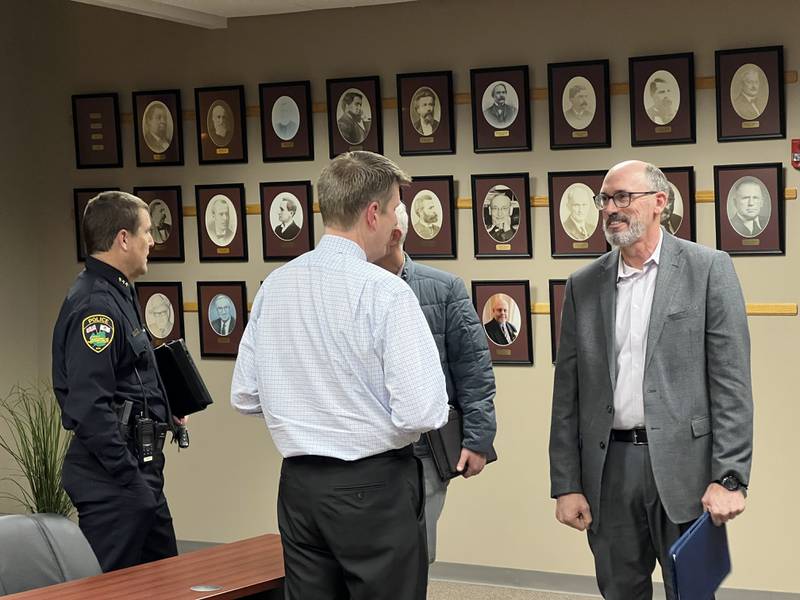 Sycamore Police Chief Jim Winters (left) talks with Public Works Director Matt Anderson while City Manager Michael Hall (middle) speaks with St. Charles Deputy Police Chief Erik Mahan (right) after Sycamore City Council meeting on March 3, 2025. Mahan is expected to be sworn in and replace Winters as Sycamore Police Chief on March 17, 2025.