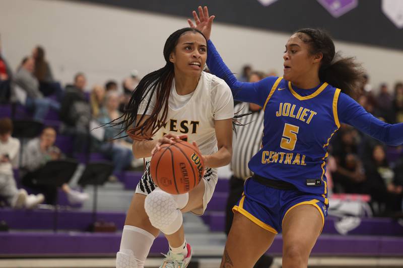 Joliet West’s Alaya Redditt looks to take a shot against Joliet Central at Joliet Junior College.