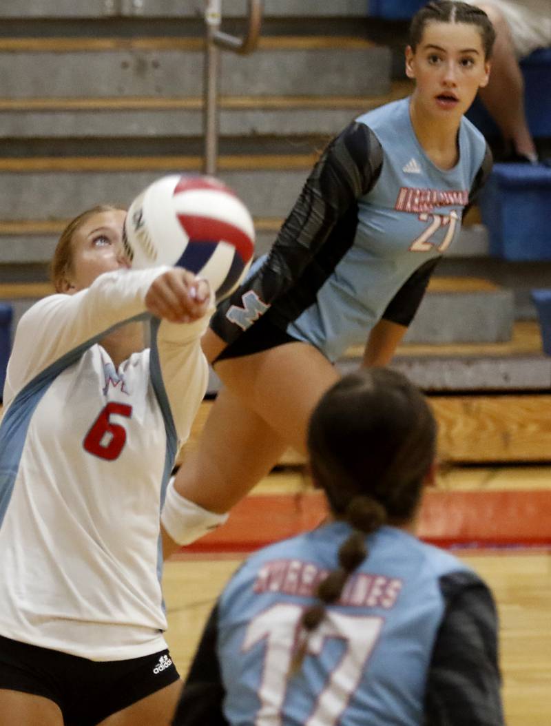 Marian Central's Meredith Bucci bump sets the ball as her teammate, Hadley Rogge, gets prepared to spike the ball during a nonconference volleyball match against McHenry Monday, Aug. 28, 2023, at Marian Central Catholic High School.