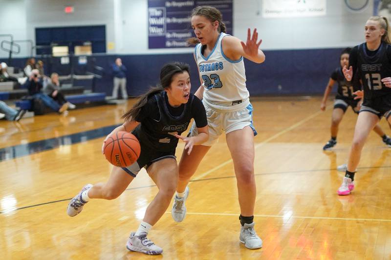 Oswego East's Anna Tran (2) drives to the basket against Downers Grove South's Addison Bryant (23) during a 4A Oswego East Regional semifinal girls basketball game at Oswego East High School on Monday, Feb 12, 2024.
