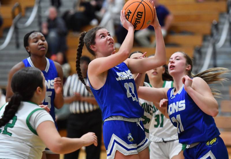 Lyons Township’s Emma O’Brien puts the ball up in a crowd during a game against York on February 4, 2025 at York High School in Elmhurst.