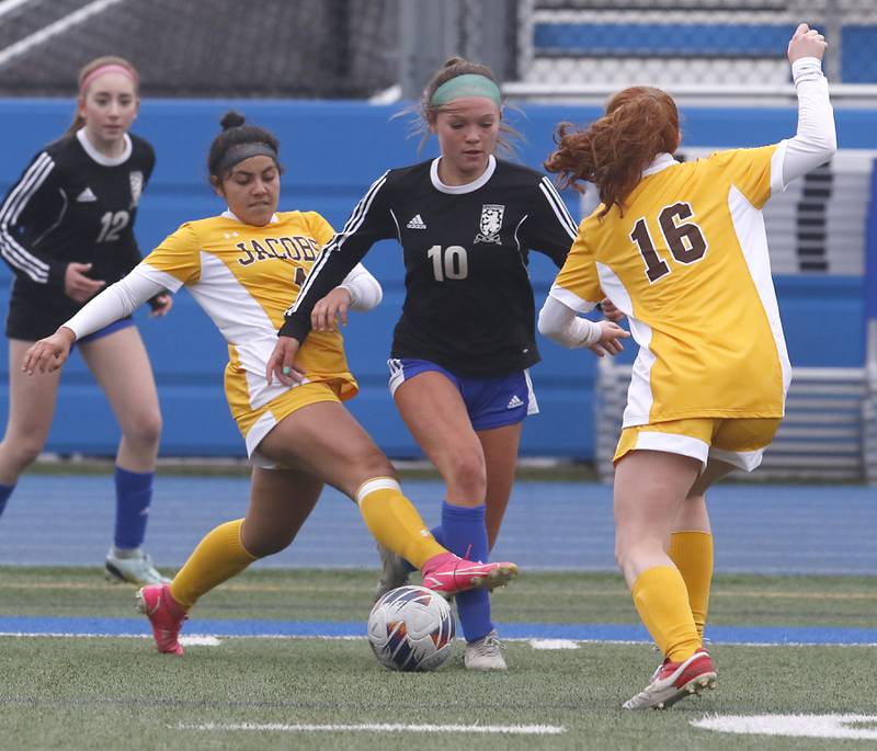 Jacobs' Sam Diaz (left) and her teammate, Delaney Lukowski try to take the ball from Lake Zurich’s Delilah Swartwood during a nonconference girls soccer match Tuesday, April 4, 2023, at Lake Zurich High School.