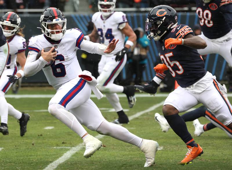 New York Giants quarterback Jaxson Dart tries to hold off Chicago Bears safety C.J. Gardner-Johnson Sunday, Nov. 9, 2025, during their game at Soldier Field in Chicago.