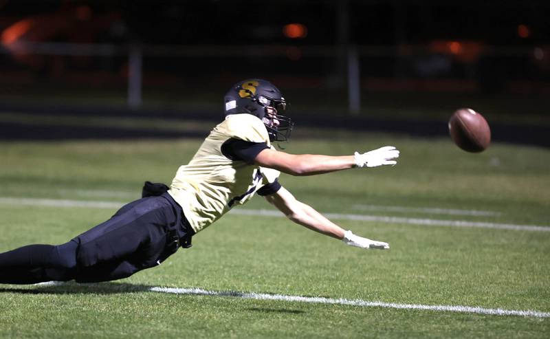 Sycamore's Thatcher Friedrichs dives for a pass during their game against Woodstock North Friday Oct. 7, 2022, at Sycamore High School.